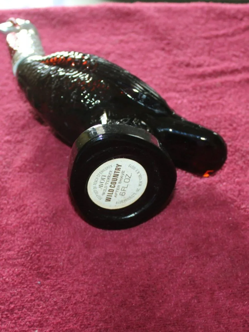 Vintage Avon Wild Turkey bottle, featuring brown glass and a silver-colored head